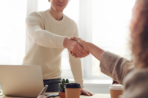 a person shaking hands in a professional setting