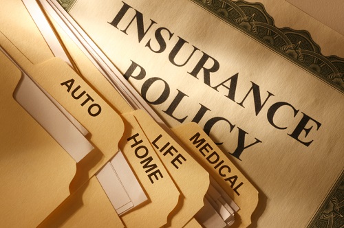 multiple folders of various insurance policies